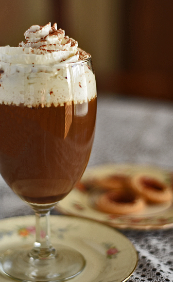 A glass A Hill of Beans coffee flavored with chocolate and a hint of eggnog, topped with whipped cream.